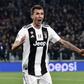 Juventus' forward Mario Mandzukic (L) celebrates as Valencia's midfielder Daniel Wass reacts, after opening the scoring during the UEFA Champions League group H football match Juventus vs Valence November 27, 2018