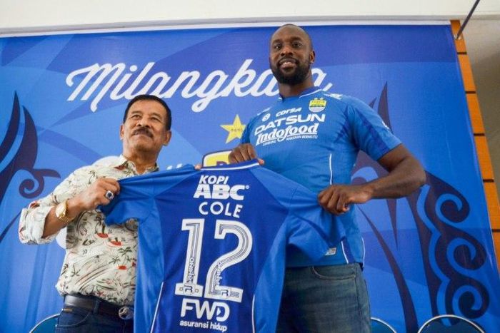 Former West Ham and Chelsea striker Carlton Cole (R) and Persib manager Umuh Muhtar hold up Cole's jersey during a press conference in Bandung, Indonesia on March 30, 2017