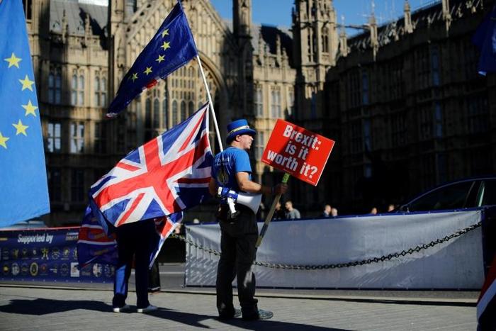 Anti-Brexit campaigner Steve Bray holds a placard asking "Brexit: is it worth it?" as a no-deal scenario looms ever larger, leading some observers to warn of chaos, not least regarding cross-Channel transport links