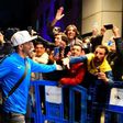 Carlos Tevez greets Boca Juniors supporters as his team arrive in Madrid for the delayed second leg of the Copa Libertadores final