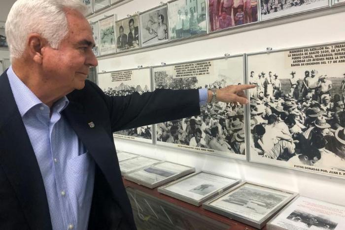 Johnny Lopez de la Cruz, a Cuban who is president of the Bay of Pigs Veterans Association, points to himself in a picture featured in the Brigade 2506 Museum in Little Havana, Miami