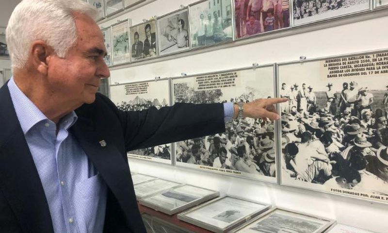 Johnny Lopez de la Cruz, a Cuban who is president of the Bay of Pigs Veterans Association, points to himself in a picture featured in the Brigade 2506 Museum in Little Havana, Miami
