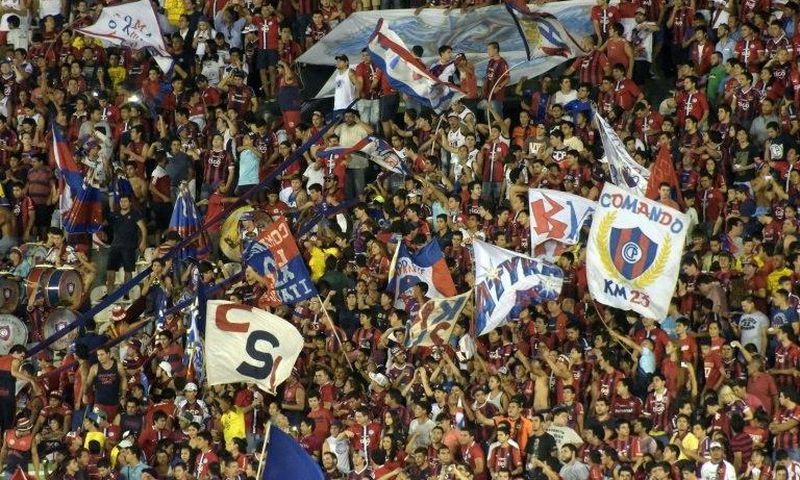 Fans of Paraguay's Cerro Porteno cheer for their team during their Copa Libertadores 2016 football match against Colombia's Independiente de Santa Fe at Defensores del Chaco stadium in Asuncion, on April, 20, 2016