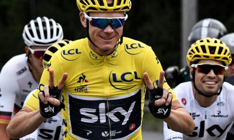 Great Britain's Chris Froome (C) flashes victory signs during the twenty-first and last stage of the Tour de France on July 23, 2017