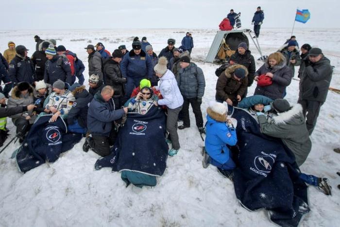 Rescuers pulled the crew members out of the capsule