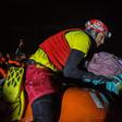 A member of Proactiva Open Arms organisation holds a new born baby rescued with her mother