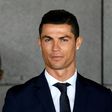 Portuguese footballer Cristiano Ronaldo stands next to a bust in his likeness presented during a ceremony renaming Madeira's airport in Funchal after the footballer on March 29, 2017