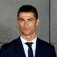 Portuguese footballer Cristiano Ronaldo stands next to a bust in his likeness presented during a ceremony renaming Madeira's airport in Funchal after the footballer on March 29, 2017