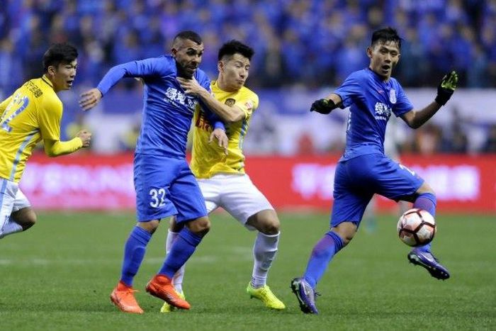 Carlos Tevez (2L) faces calls to leave Shanghai Shenhua after inconsistent performances since joining the club earlier this year