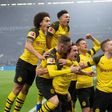 Thomas Delaney (bottom centre) is mobbed by his Dortmund team-mates after scoring against Schalke