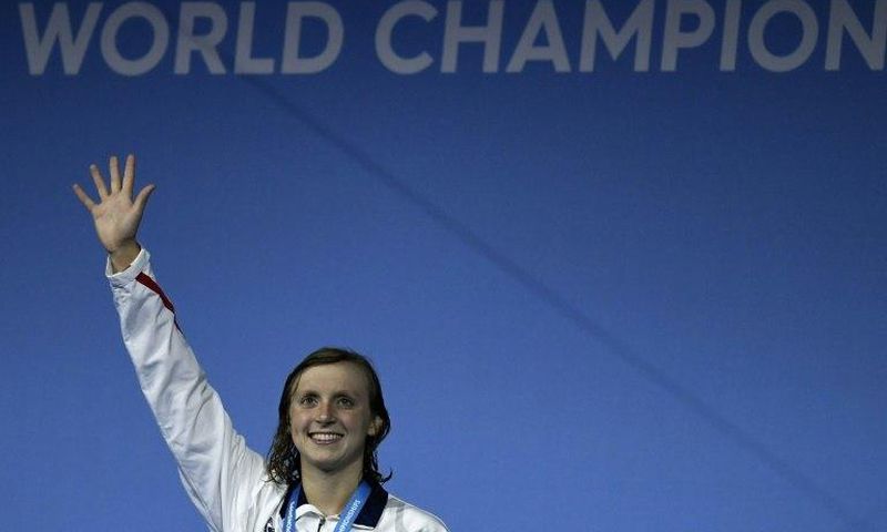 American Katie Ledecky celebrates on the podium after the women's 1500m freestyle final on July 25, 2017