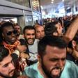 French forward Bafetimbi Gomis (centre) is escorted outside the Ataturk International airport as he is greeted by fans upon his arrival, on June 28, 2017 in Istanbul