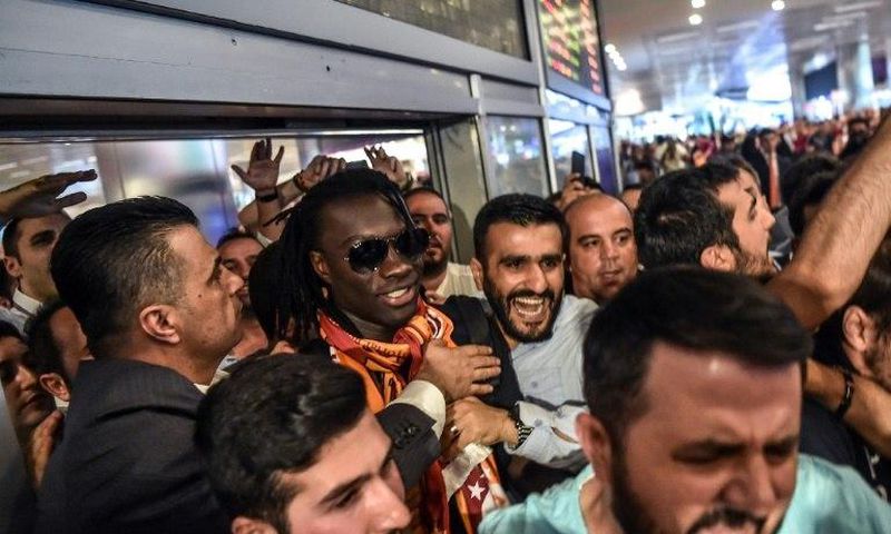 French forward Bafetimbi Gomis (centre) is escorted outside the Ataturk International airport as he is greeted by fans upon his arrival, on June 28, 2017 in Istanbul