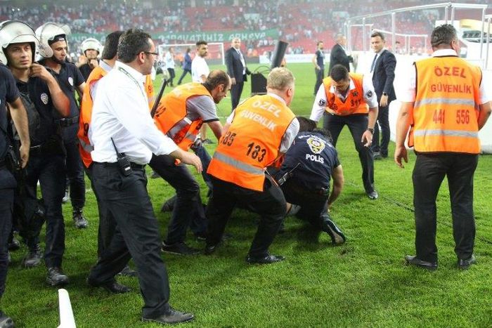 Turkish police detain a supporter after football fans invaded the pitch during the Super Cup match between Besiktas and Konyaspor on August 6, 2017