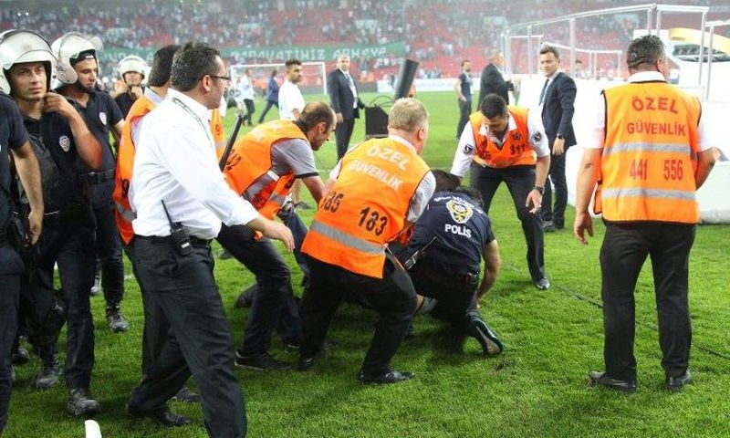 Turkish police detain a supporter after football fans invaded the pitch during the Super Cup match between Besiktas and Konyaspor on August 6, 2017