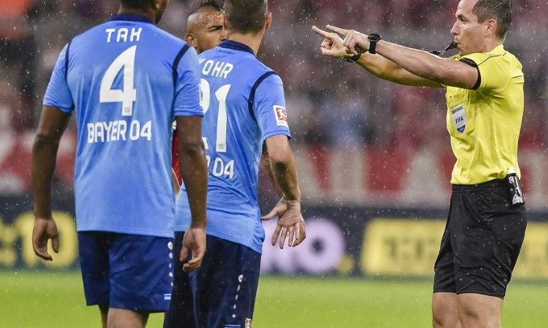 German referee Tobias Stieler gestures for the video assistant referee to review a decision during the Bundesliga match between Bayern Munich and Bayern Leverkusen on August 18, 2017