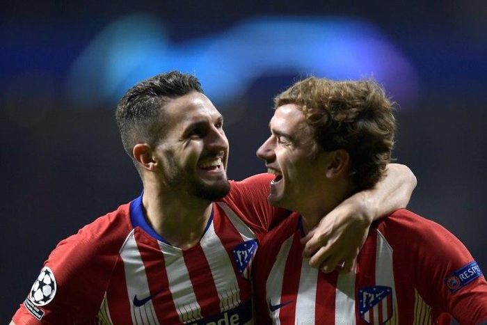 Atletico Madrid's Koke and Antoine Griezmann celebrate reaching the Champions League last 16 with a 2-0 victory over Monaco