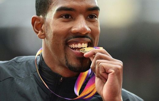 Gold medallist US athlete Christian Taylor poses on the podium during the victory ceremony for the men's triple jump athletics event at the 2017 IAAF World Championships at the London Stadium in London August 11, 2017