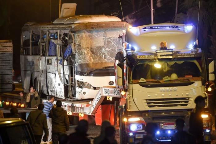 This picture taken on December 28, 2018 shows a tourist bus which was hit by a deadly bombing being towed away from the scene in Giza province south of the Egyptian capital Cairo