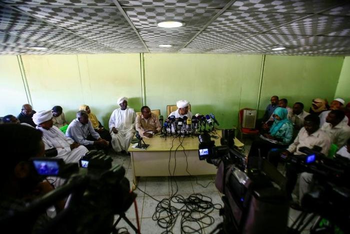 Journalists gather at a press conference by Idris Suleman, a senior official from the Popular Congress Party, in Khartoum on December 26, 2018