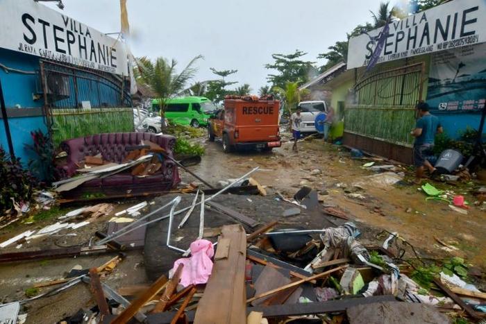 Debris from damaged buildings is strewn across a road in Carita after the area was hit by a tsunami following an eruption of the Anak Krakatoa volcano
