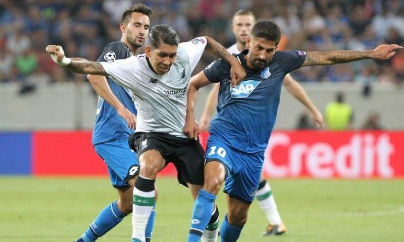 Hoffenheim midfielder Kerem Demirbay (R) grapples with Liverpool midfielder Roberto Firmino during the Champions League qualifier first leg in Sinsheim, Germany, on August 15, 2017