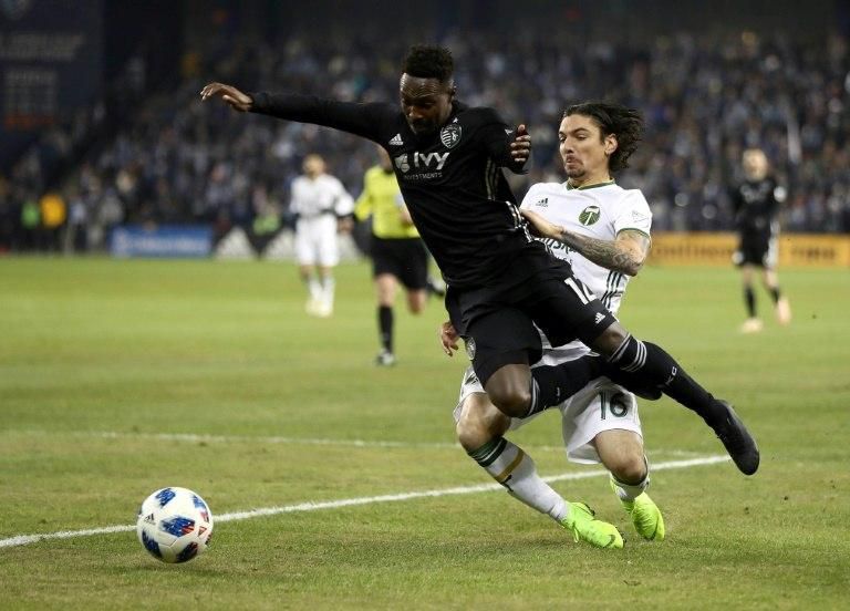 Gerso of Sporting Kansas City is upended by Zarek Valentin of Portland Timbers during leg 2 of the Western Conference Championship, at Children's Mercy Park in Kansas City, on November 29, 2018