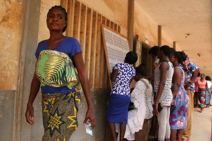 Voters consult an electoral notice in Lome's Be neighbourhood on polling day with 14 opposition groups urging a boycott citing "irregularities" and demanding constitutional reform