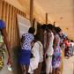 Voters consult an electoral notice in Lome's Be neighbourhood on polling day with 14 opposition groups urging a boycott citing "irregularities" and demanding constitutional reform
