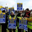 Historic Royal Palaces staff hold placards on a picket line, striking strike over pensions outside the Tower of London