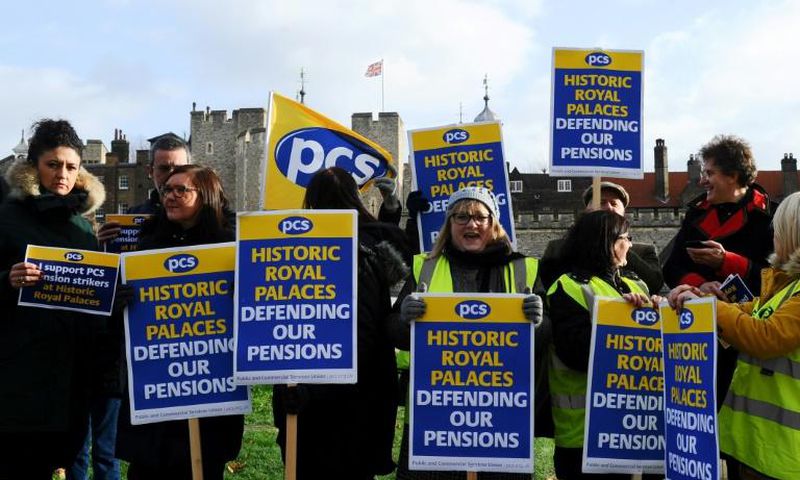 Historic Royal Palaces staff hold placards on a picket line, striking strike over pensions outside the Tower of London