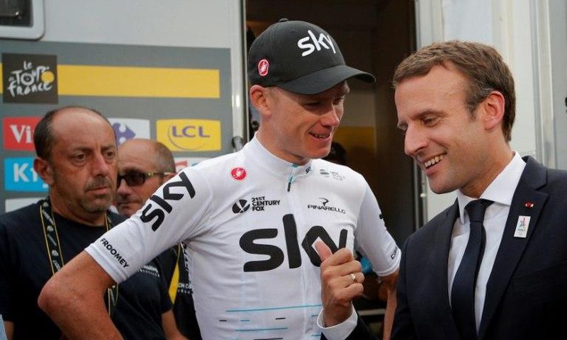 French President Emmanuel Macron (R) talks to overall leader, Britain's Chris Froome, after the 183km 17th stage of the 104th edition of the Tour de France cycling race, in Serre-Chevalier, on July 19, 2017