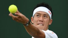 Japan's Kei Nishikori serves against Italy's Marco Cecchinato during their men's singles first round match on the first day of the 2017 Wimbledon Championships at The All England Lawn Tennis Club in Wimbledon, southwest London, on July 3, 2017