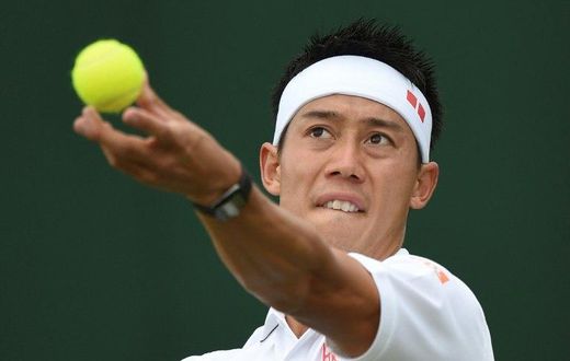 Japan's Kei Nishikori serves against Italy's Marco Cecchinato during their men's singles first round match on the first day of the 2017 Wimbledon Championships at The All England Lawn Tennis Club in Wimbledon, southwest London, on July 3, 2017