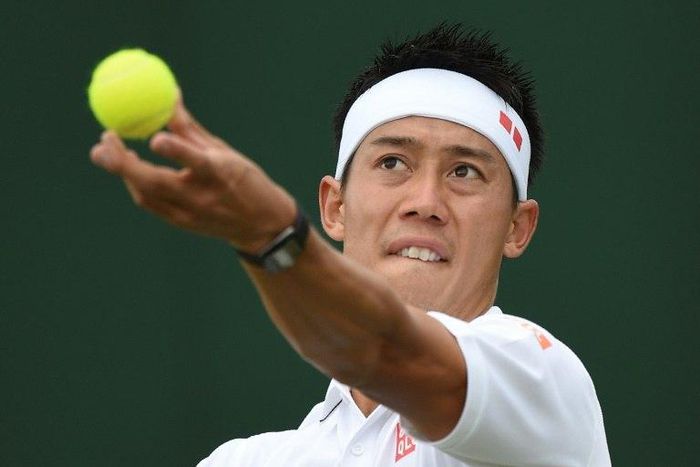Japan's Kei Nishikori serves against Italy's Marco Cecchinato during their men's singles first round match on the first day of the 2017 Wimbledon Championships at The All England Lawn Tennis Club in Wimbledon, southwest London, on July 3, 2017