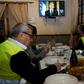 'Yellow vest' protestors take notes as they watch French President Emmanuel Macron's speech on television