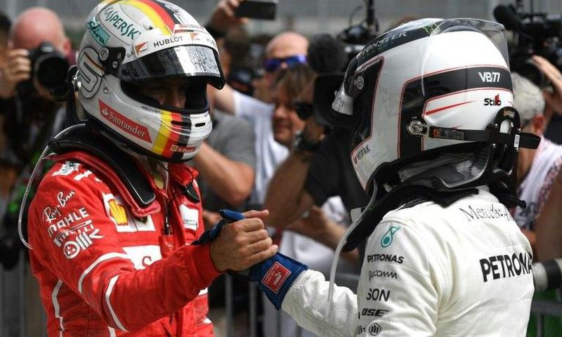Mercedes driver Valtteri Bottas (right) shakes hands with Ferrari's Sebastian Vettel after the Austraian Grand Prix at the Red Bull Ring in Spielberg on July 9, 2017