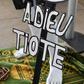 A supporter holding a sign reading "Farewell Tiote" attends the arrival of the casket of the late Ivory Coast midfielder Cheick Tiote, on June 15, 2017 upon its arrival from China at Abidjan's airport, prior to his funeral ceremony