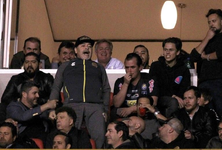 Maradona, standing, had to watch the final from the stands after being sent off near the end of his team's first-leg victory for launching a tirade against officials