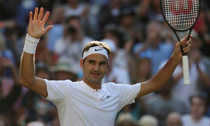 Switzerland's Roger Federer celebrates beating Canada's Milos Raonic during their men's singles quarter-final match on the ninth day of the 2017 Wimbledon Championships July 12, 2017