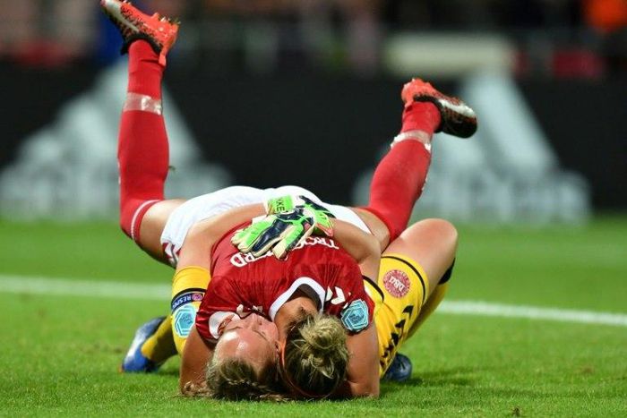 Denmark's goalkeeper Stina Lykke Petersen (down) and Sanne Troelsgaard celebrate on July 24, 2017