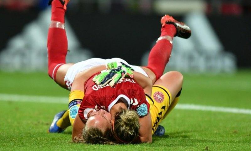 Denmark's goalkeeper Stina Lykke Petersen (down) and Sanne Troelsgaard celebrate on July 24, 2017