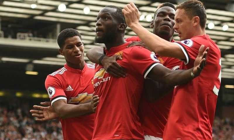 Manchester United's Romelu Lukaku celebrates with teammates after scoring a goal during their English Premier League match against West Ham United, at Old Trafford in Manchester, on August 13, 2017