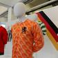 (From L) A football shirt from Italy, from the 80s, an England away shirt from 1966 and a Netherlands shirt from 1988, seen at 'The Art of the Football Shirt' exhibition in London, on July 26, 2017