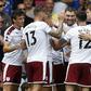 Burnley's Welsh striker Sam Vokes (C) celebrates with teammates after scoring the opening goal of the English Premier League football match between Chelsea and Burnley at Stamford Bridge in London on August 12, 2017