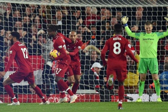 Liverpool players celebrate Divock Origi's late winning goal against Everton after a Jordan Pickford error