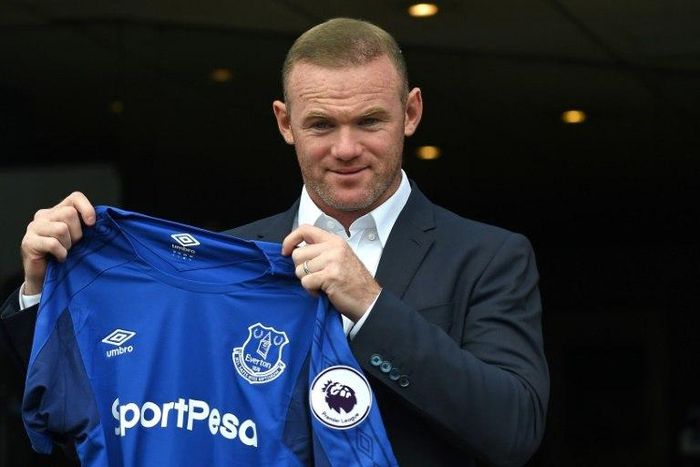 Wayne Rooney poses with the Everton shirt after his return to the club from Manchester United