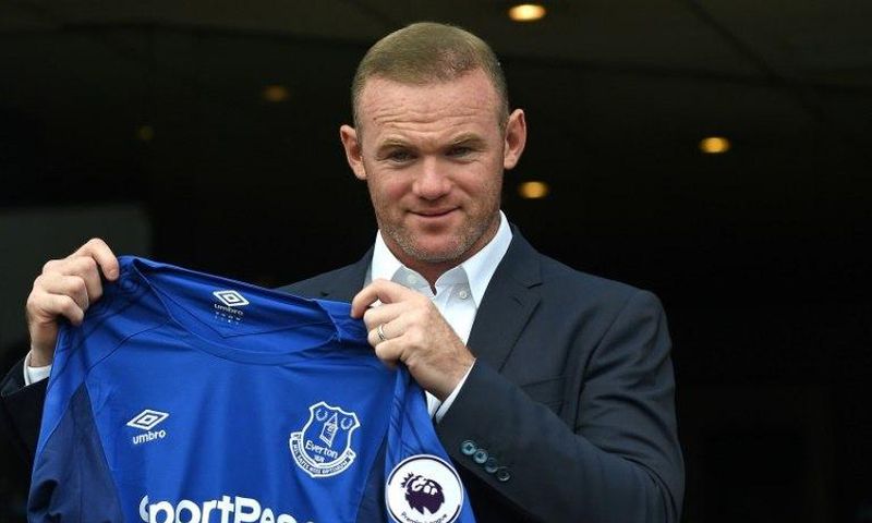 Wayne Rooney poses with the Everton shirt after his return to the club from Manchester United