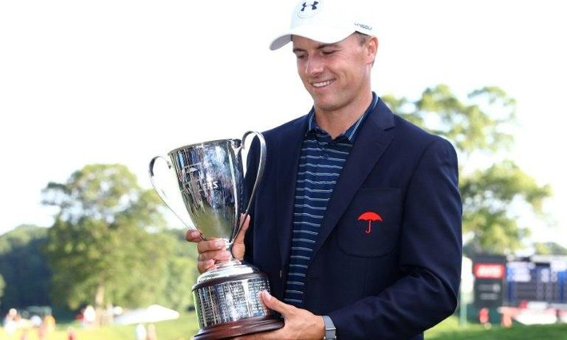 Jordan Spieth of the US poses with the winner's trophy after defeating Daniel Berger in a playoff in the final round of the Travelers Championship, at TPC River Highlands in Cromwell, Connecticut, on June 25, 2017