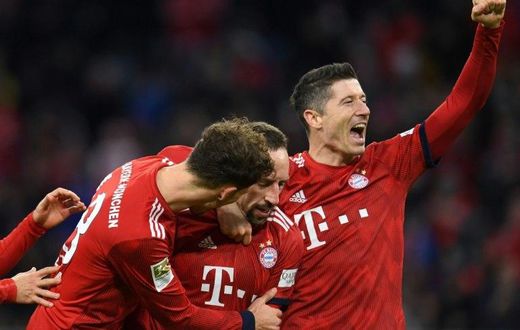 Bayern Munich's Polish striker Robert Lewandowski (R), who scored their first two goals, celebrates after Franck Ribery netted a late third in Saturday's 3-0 win against Nuremberg to lift the defending champions to third in the league table.